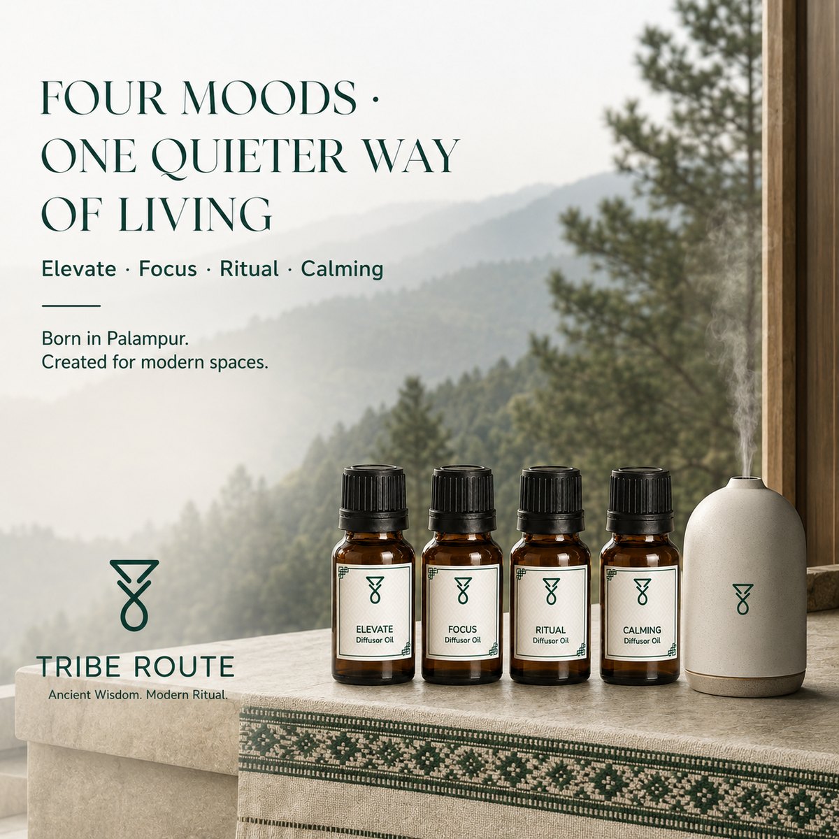 Four diffuser oils beside a ceramic diffuser with a Himalayan forest view